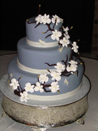 Picture of a beautiful Asian themed wedding cake with flowers all around it